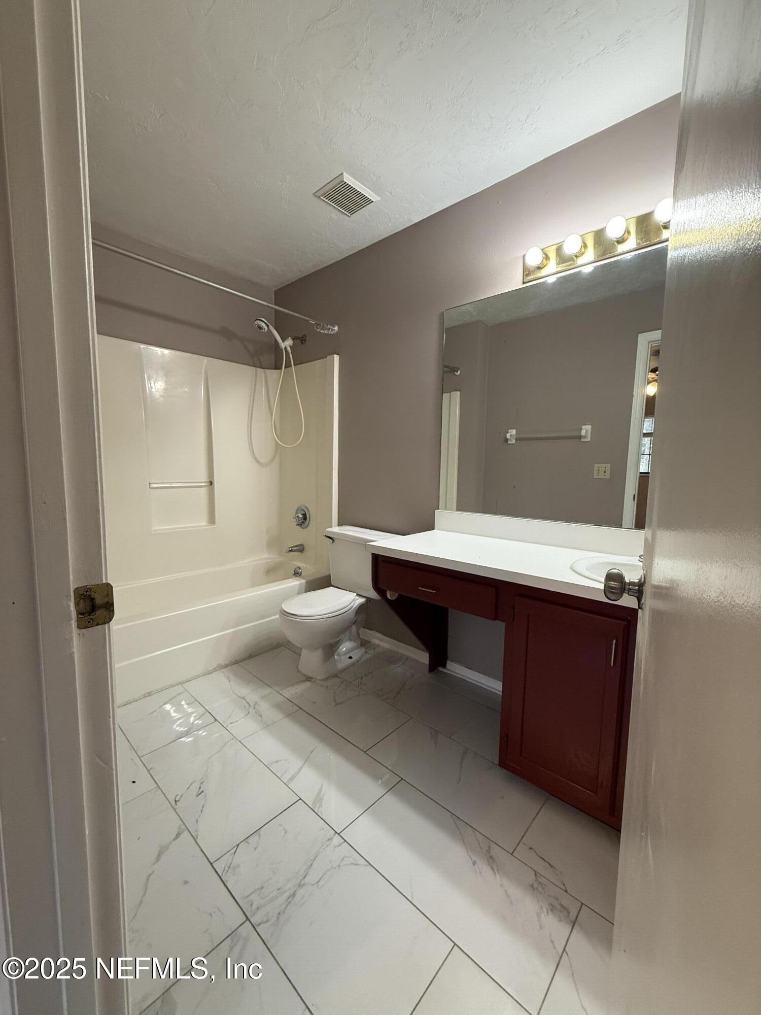 5864 Southwest 8th Place Gainesville, FL 32607 - Photo 5 of 8 a bathroom with a sink double vanity and a mirror