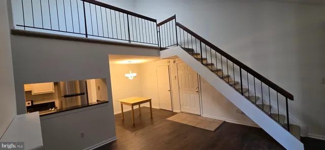 a view of livingroom with wooden floor and stairs
