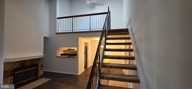 a view of staircase with wooden floor and a window