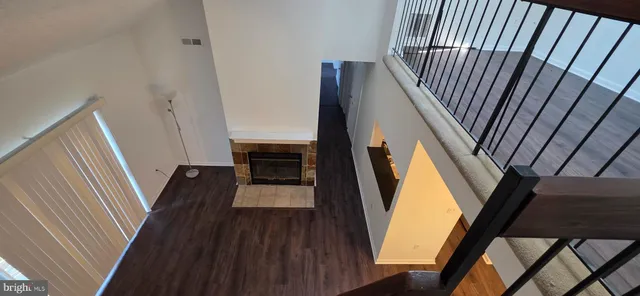 a view of a hallway view with wooden floor and staircase