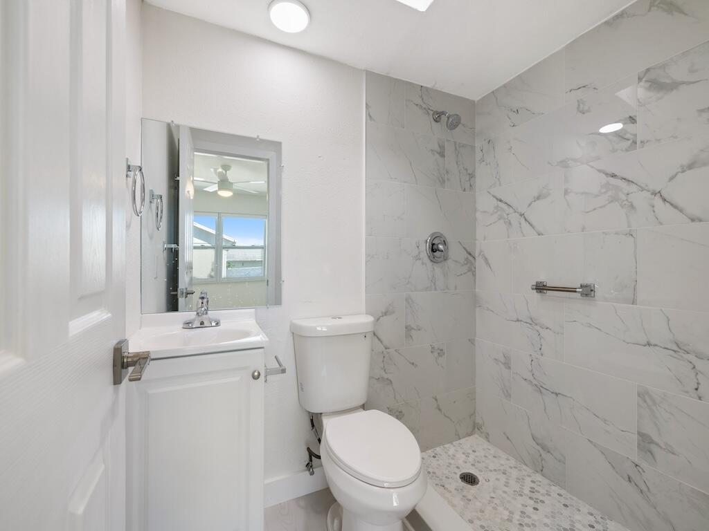 741 Hernando Street Fort Pierce, FL 34949 - Photo 19 of 65 a bathroom with a sink toilet and shower