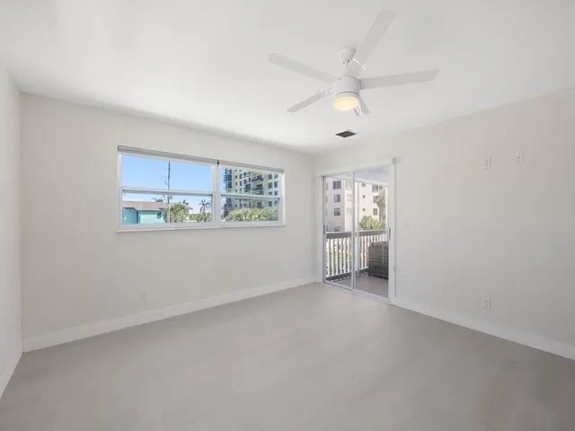 a bathroom with a granite countertop window a toilet and a shower