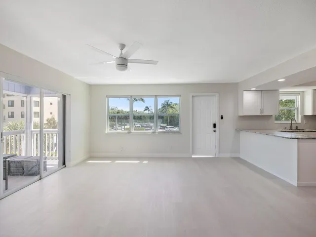 a kitchen with granite countertop white cabinets white stainless steel appliances with a sink and dishwasher