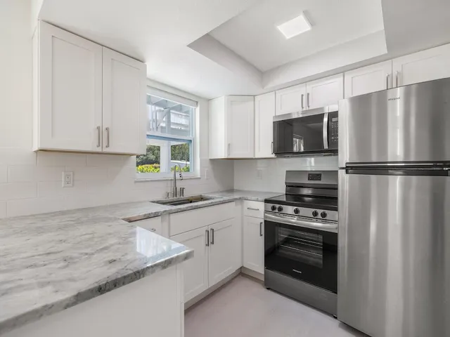 a white house with tree in the background