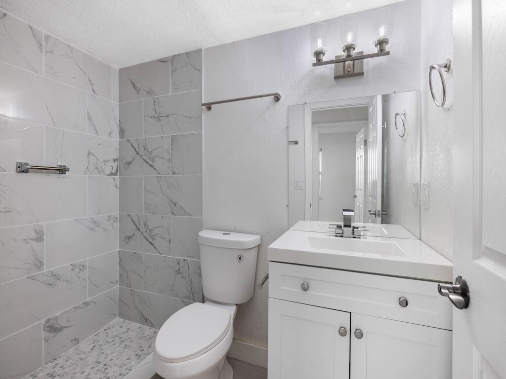 741 Hernando Street Fort Pierce, FL 34949 - Photo 46 of 65 a bathroom with a sink toilet and shower