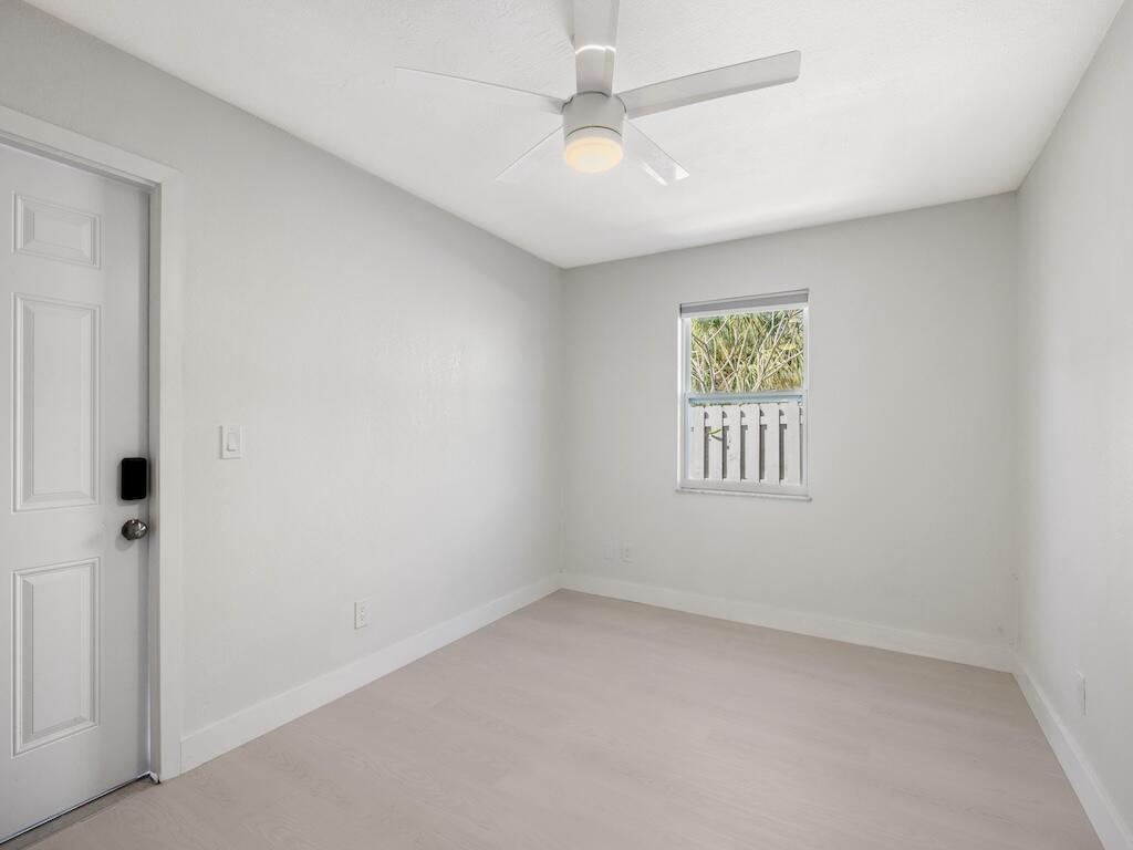 741 Hernando Street Fort Pierce, FL 34949 - Photo 48 of 65 an empty room with a window and a fan