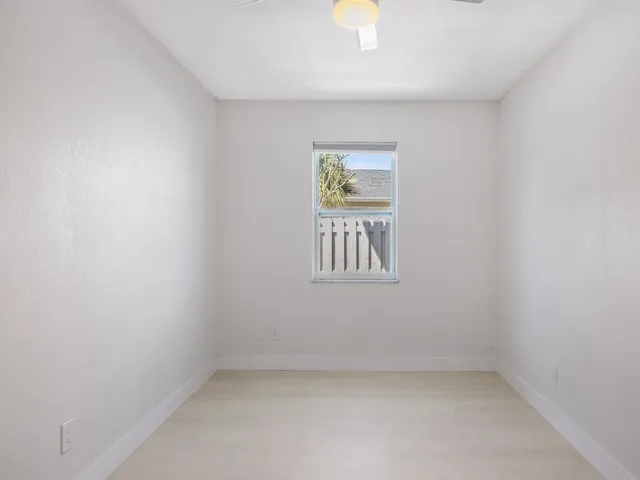 a picture of a room with a white wall and a picture