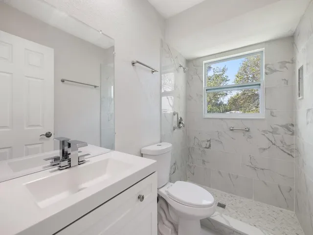 a bathroom with a sink toilet and shower
