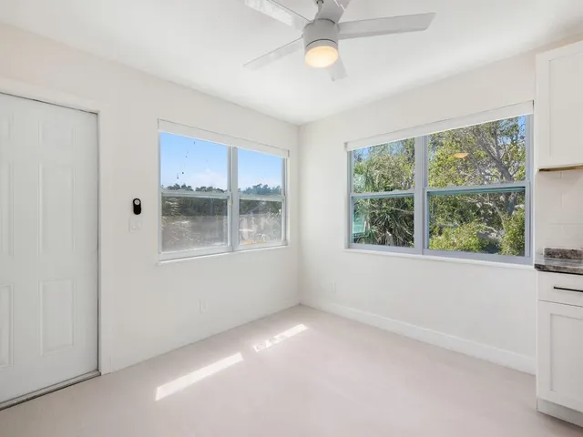 a view of wooden floor and windows in a room