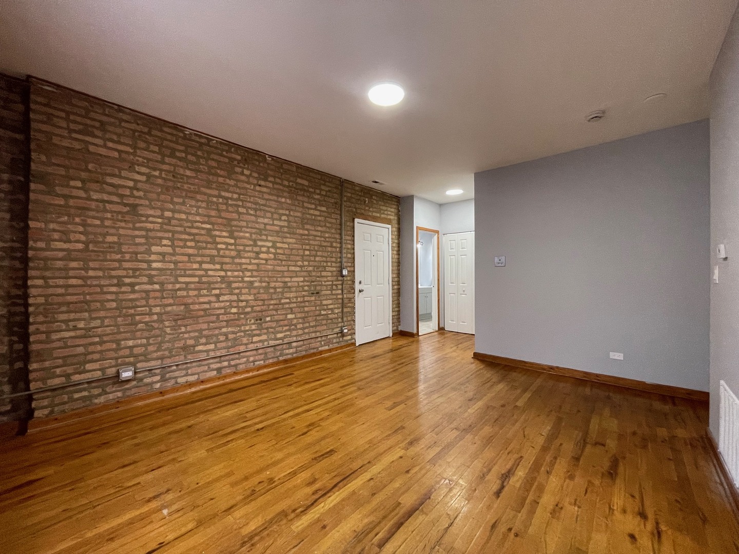 3937 West Division Street, Unit 1 Chicago, IL 60651 - Photo 3 of 11 a view of an empty room with wooden floor