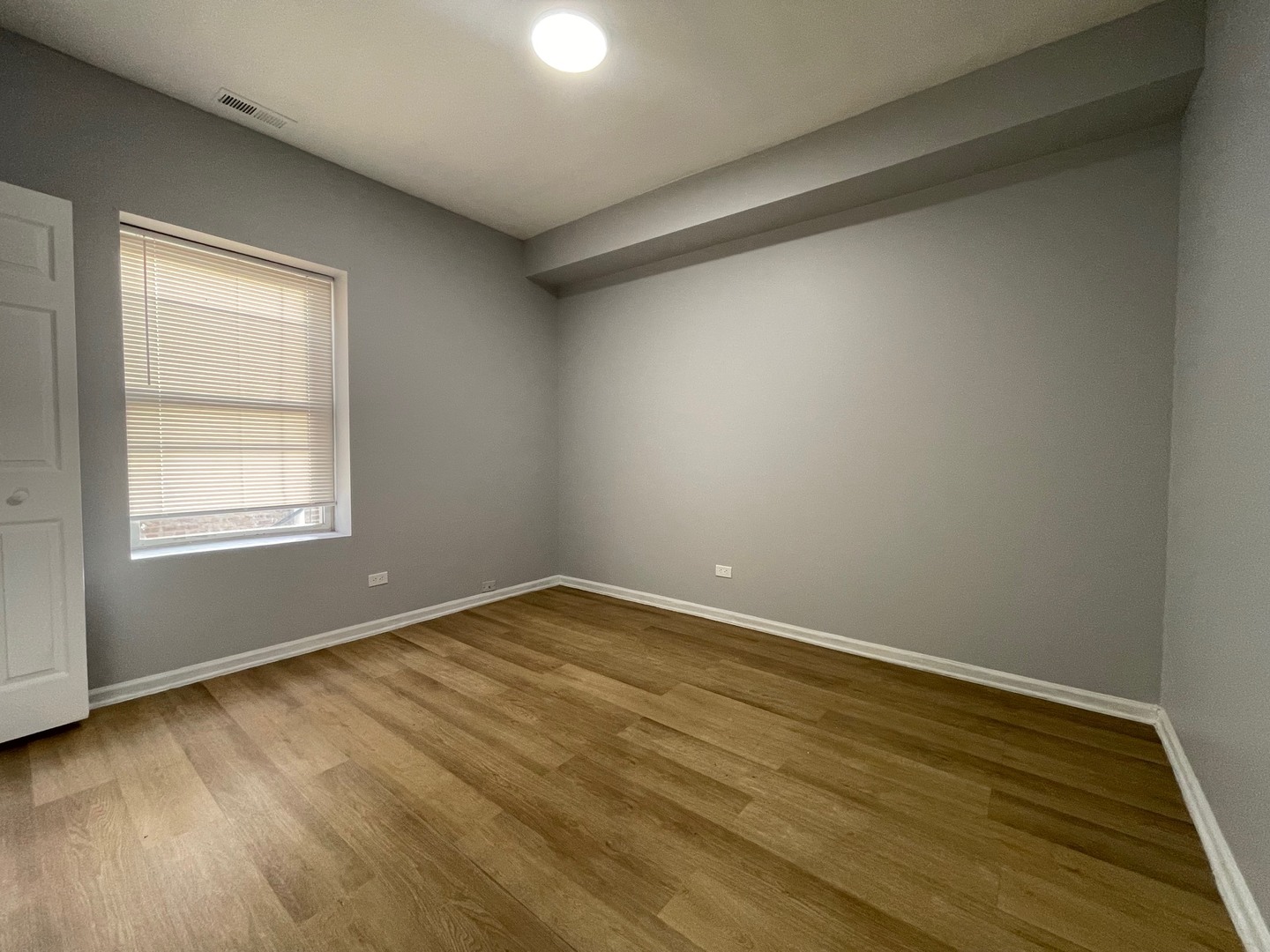 3937 West Division Street, Unit 1 Chicago, IL 60651 - Photo 8 of 11 an empty room with wooden floor and windows