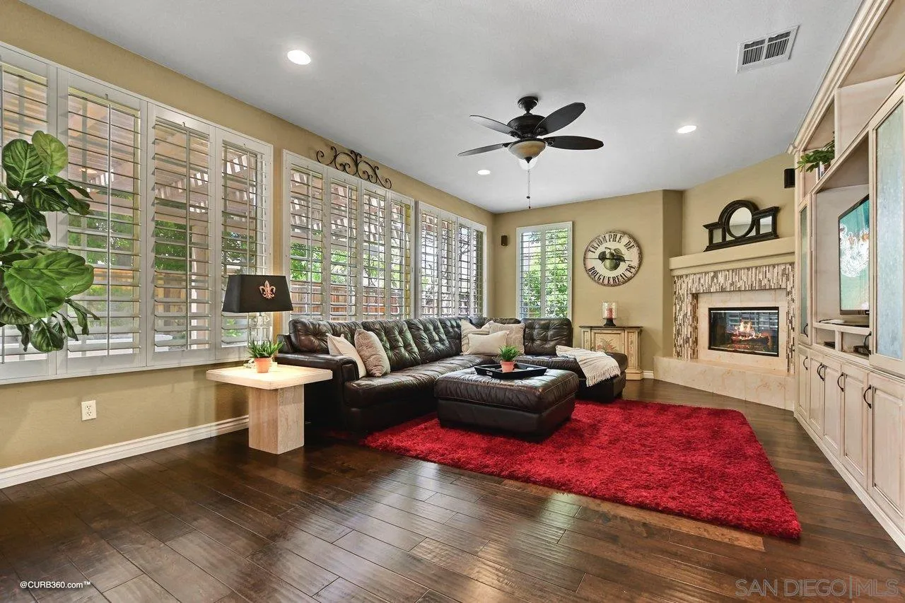16658 Deer Ridge Road San Diego, CA 92127 - Photo 12 of 44 a living room with furniture a fireplace and a potted plant