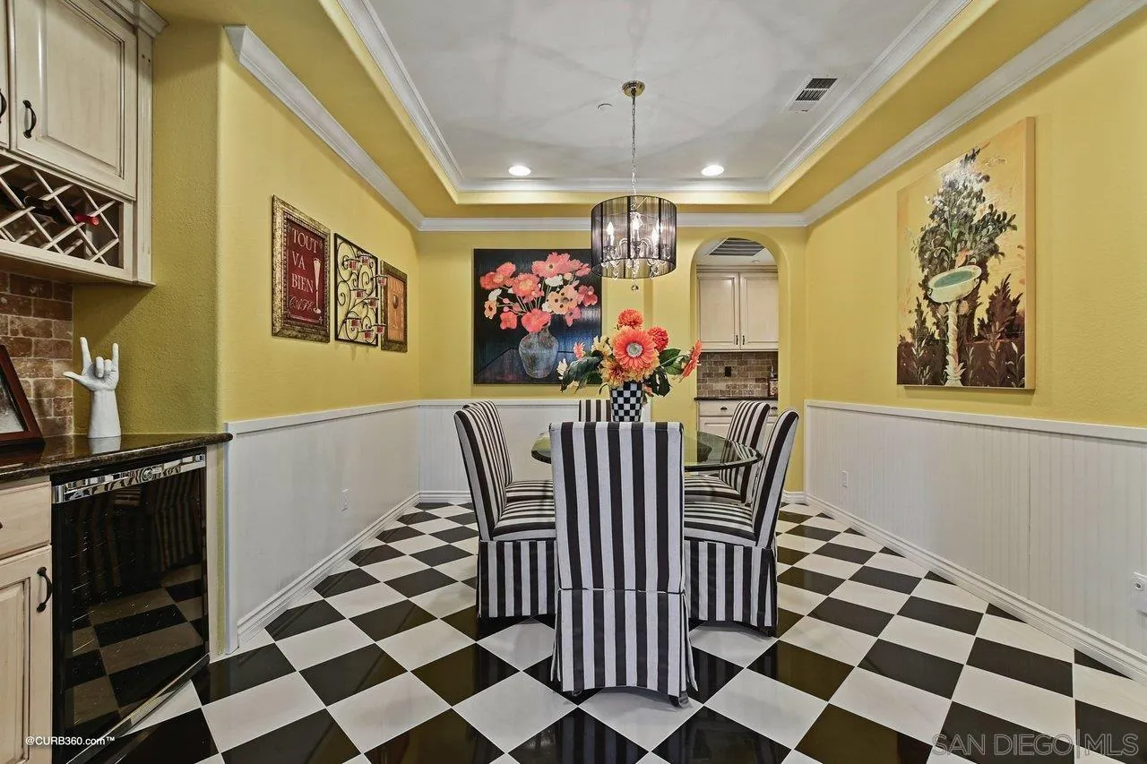 16658 Deer Ridge Road San Diego, CA 92127 - Photo 17 of 44 a view of a dining room with furniture and a chandelier
