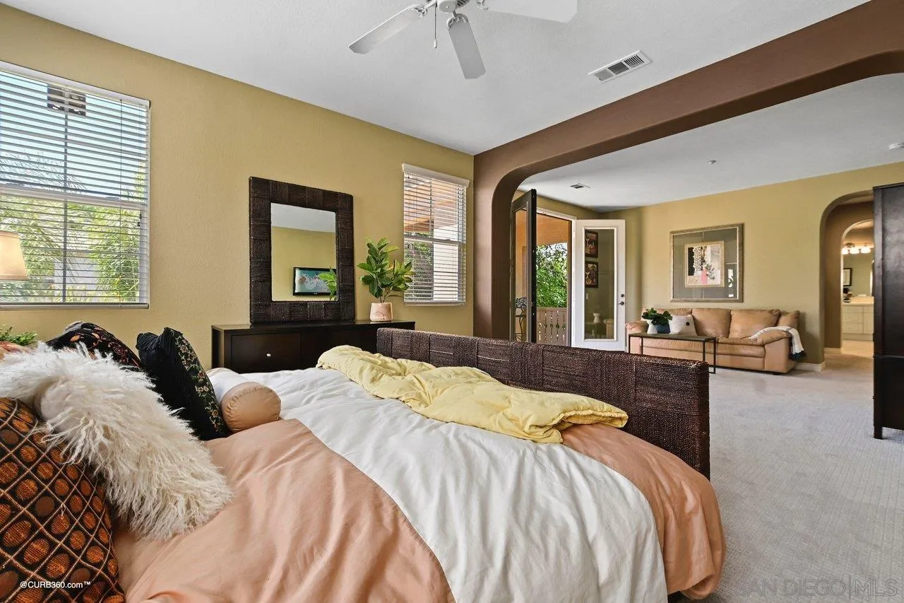 16658 Deer Ridge Road San Diego, CA 92127 - Photo 23 of 44 a bedroom with a large bed and windows