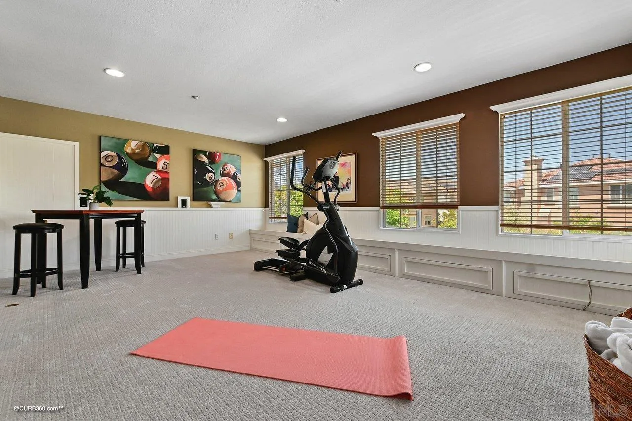 16658 Deer Ridge Road San Diego, CA 92127 - Photo 29 of 44 a living room with furniture gym equipment and a large window