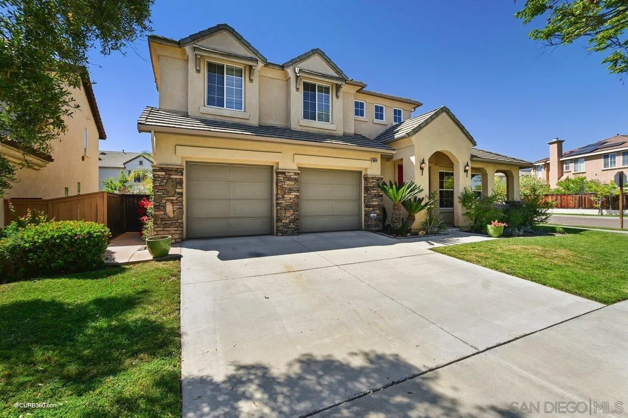 16658 Deer Ridge Road San Diego, CA 92127 - Photo 3 of 44 a front view of a house with a yard and garage