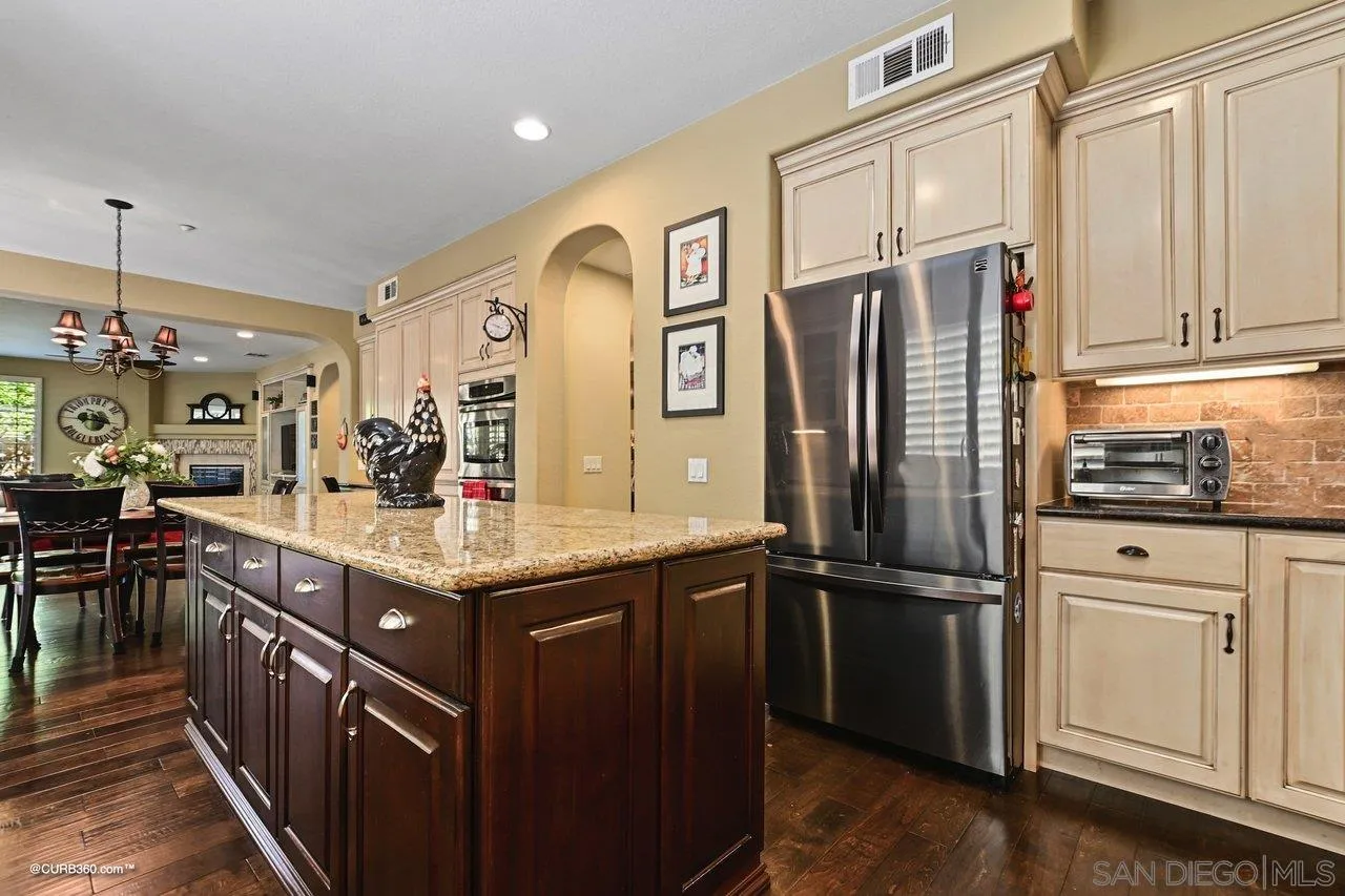 16658 Deer Ridge Road San Diego, CA 92127 - Photo 8 of 44 a kitchen with stainless steel appliances granite countertop a refrigerator a stove and a refrigerator