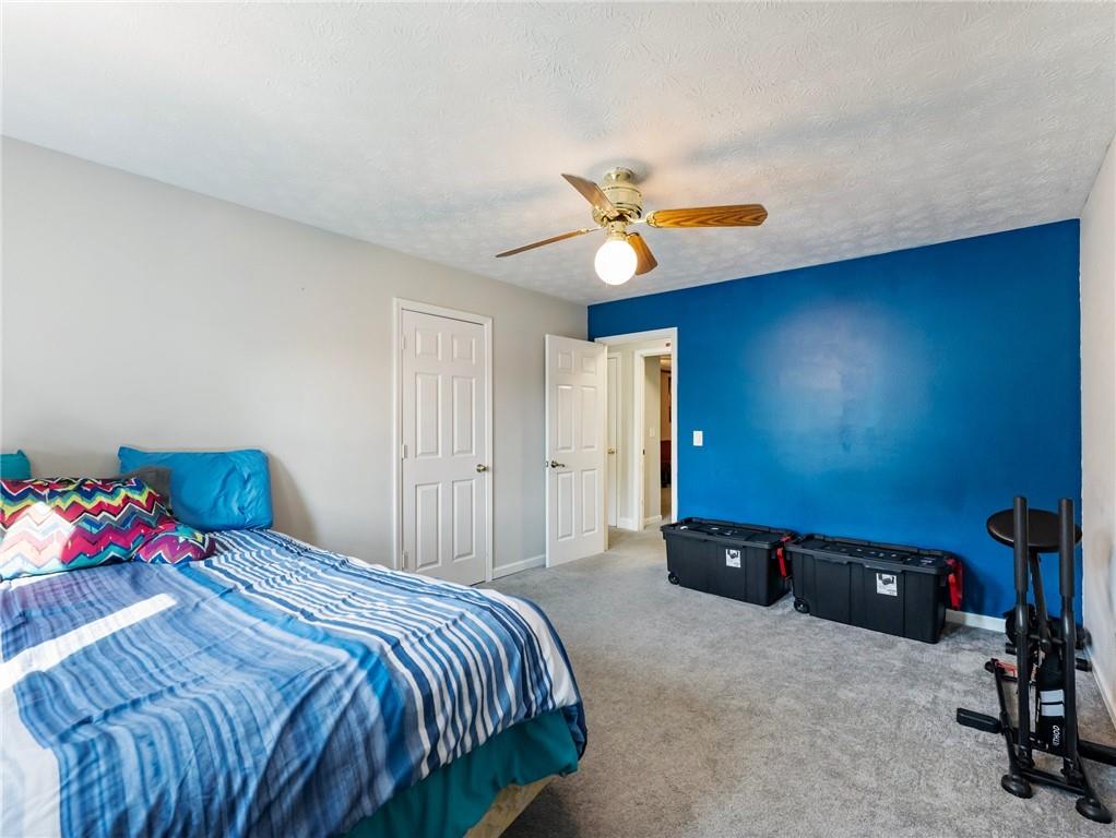 443 Rhett Drive Loganville, GA 30052 - Photo 11 of 28 a bedroom with a bed a desk and chair