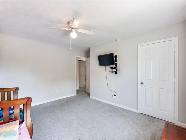 a view of an empty room with a ceiling fan