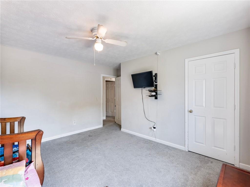 443 Rhett Drive Loganville, GA 30052 - Photo 13 of 28 a view of an empty room with a ceiling fan