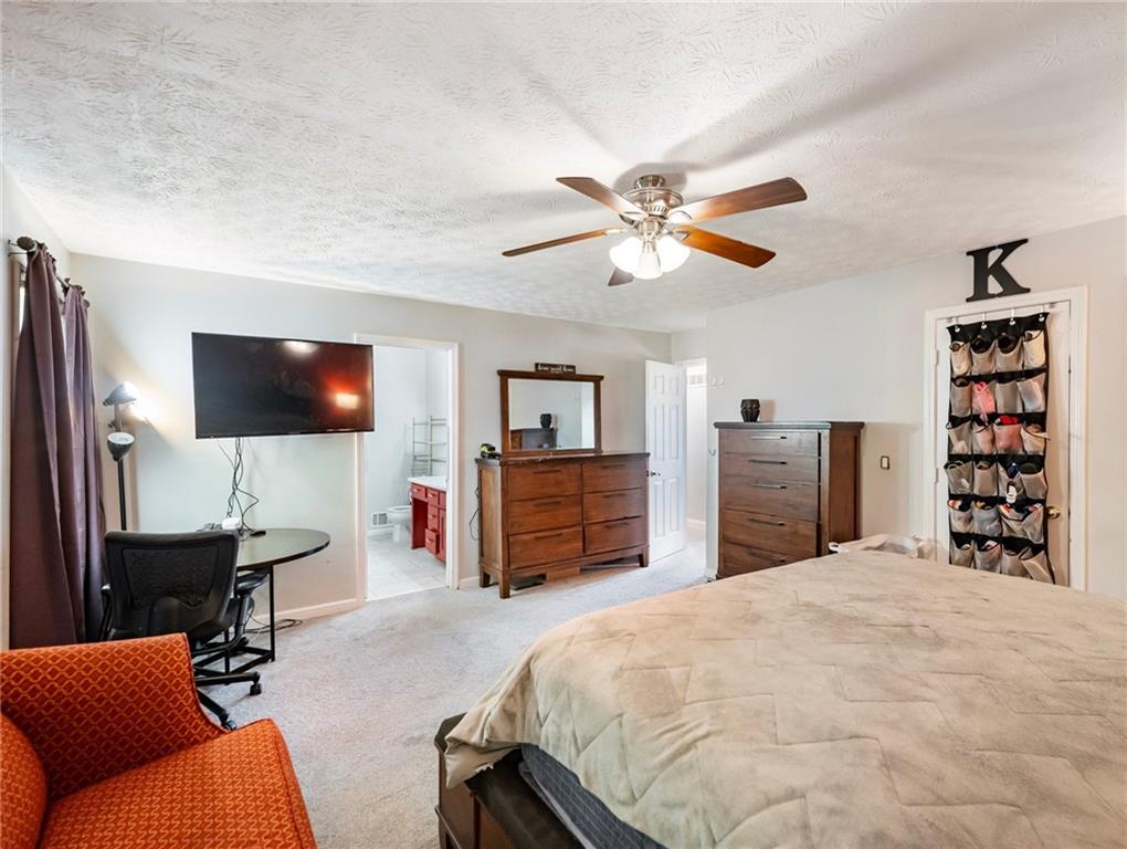 443 Rhett Drive Loganville, GA 30052 - Photo 16 of 28 a bedroom with a bed and a flat screen tv