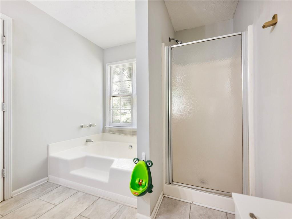 443 Rhett Drive Loganville, GA 30052 - Photo 19 of 28 a bathroom with a sink and a shower