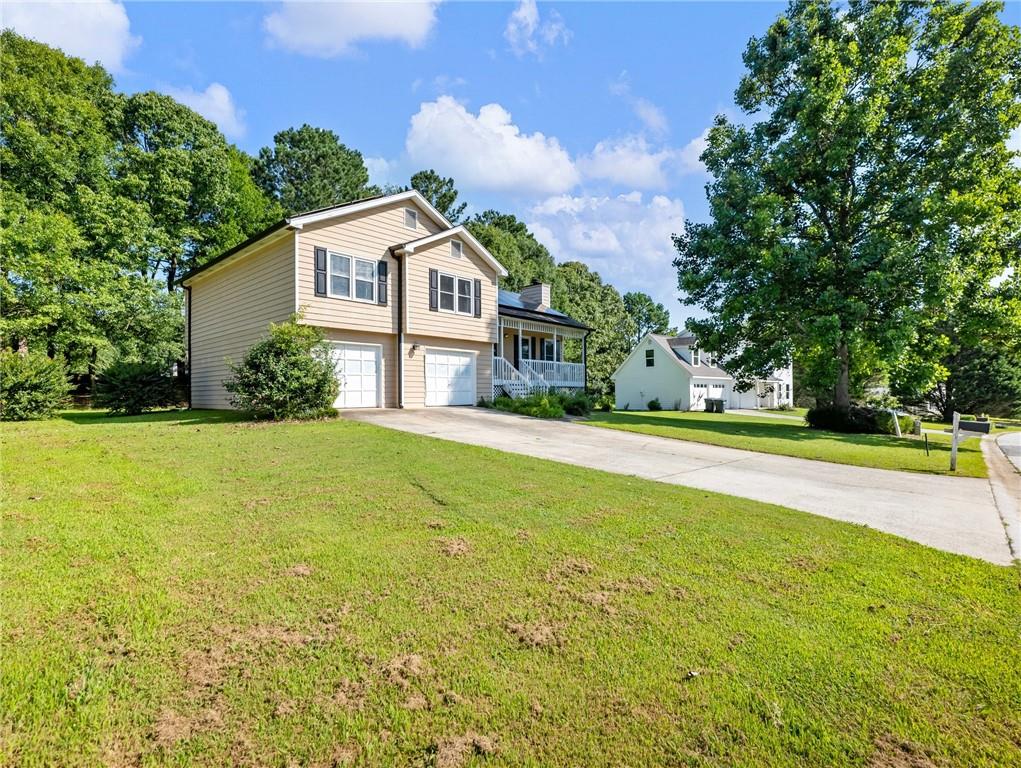 443 Rhett Drive Loganville, GA 30052 - Photo 25 of 28 a front view of house with yard and green space