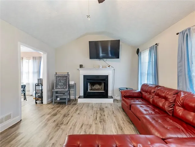 a living room with furniture fireplace and flat screen tv