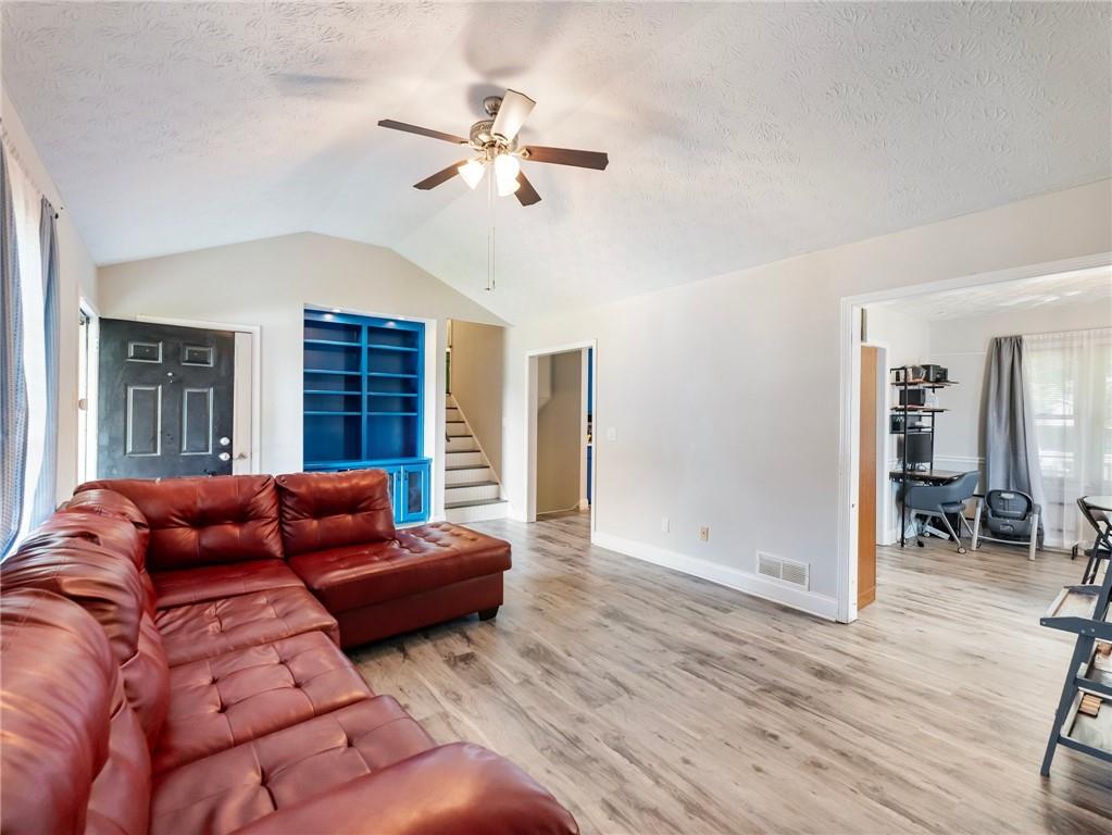 443 Rhett Drive Loganville, GA 30052 - Photo 4 of 28 a living room with furniture and a wooden floor