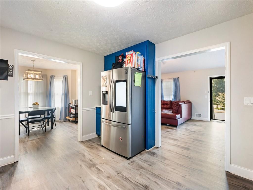 443 Rhett Drive Loganville, GA 30052 - Photo 6 of 28 a living room with furniture wooden floor and a refrigerator