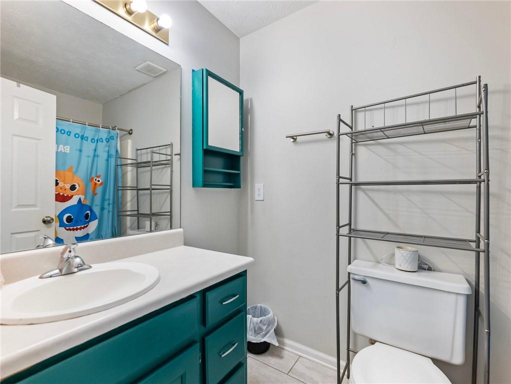443 Rhett Drive Loganville, GA 30052 - Photo 9 of 28 a bathroom with a sink toilet and shower