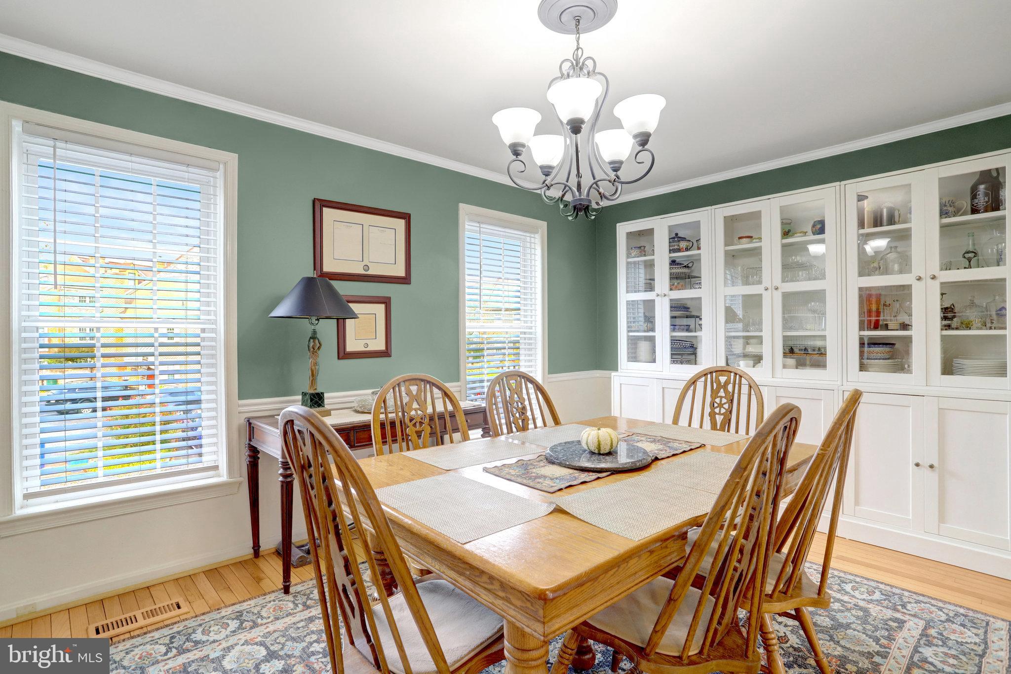 6701 Washington Boulevard, Unit B Arlington, VA 22205 - Photo 12 of 20 a view of a dining room with furniture a chandelier and wooden floor