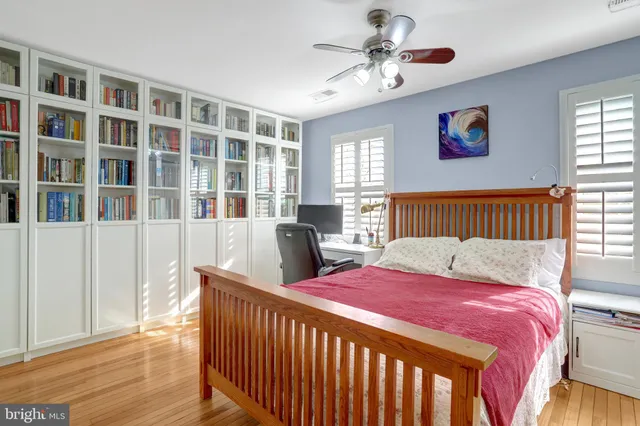 a bedroom with bed and wooden floor