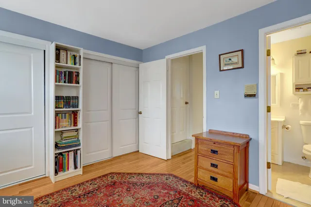 a bedroom with furniture and a book shelf