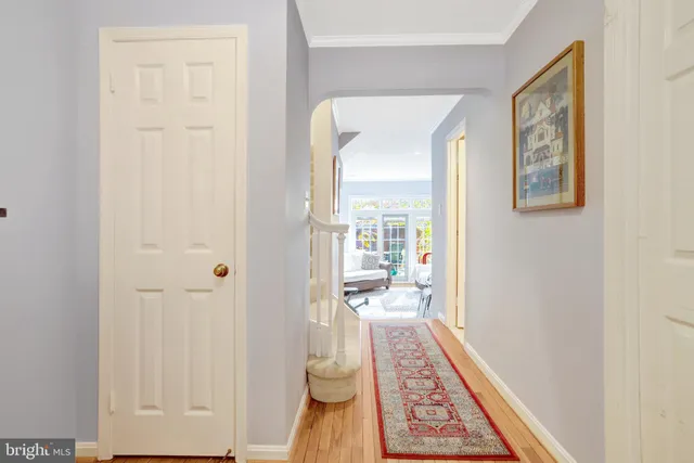 a view of a hallway and a livingroom with wooden floor