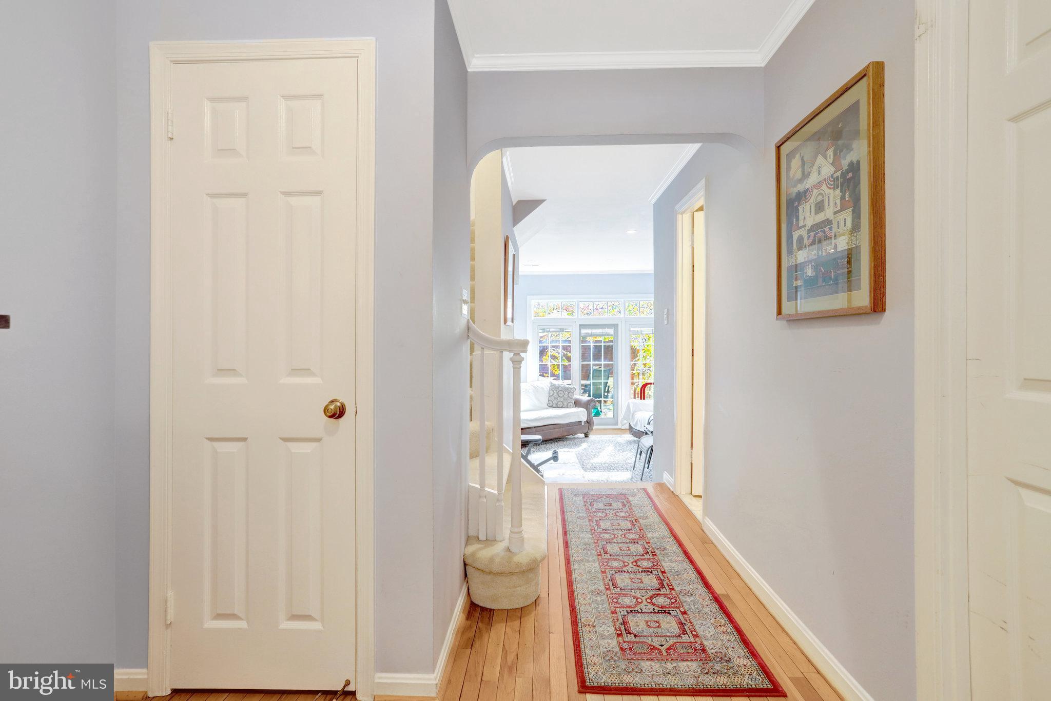6701 Washington Boulevard, Unit B Arlington, VA 22205 - Photo 3 of 20 a view of a hallway and a livingroom with wooden floor