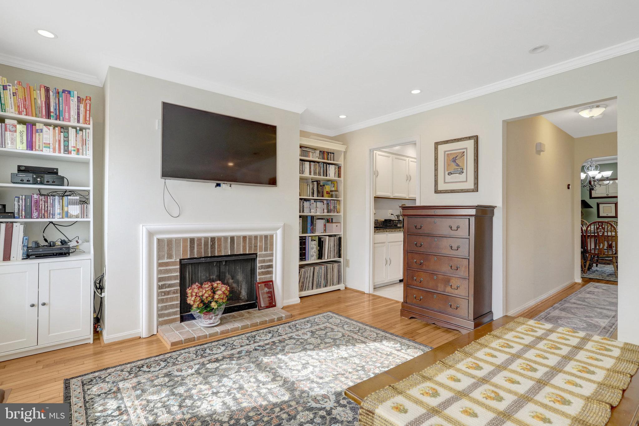 6701 Washington Boulevard, Unit B Arlington, VA 22205 - Photo 6 of 20 a living room with furniture a flat screen tv and a fireplace