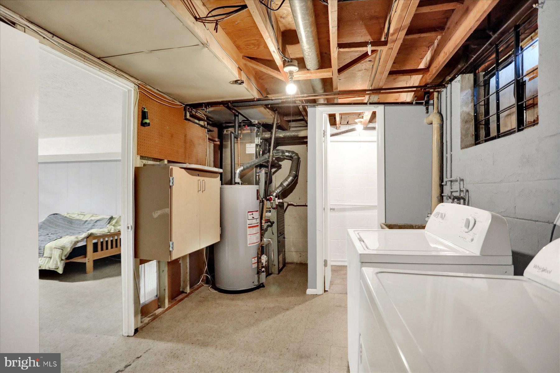 959 Elm Road Baltimore, MD 21227 - Photo 17 of 27 a view of storage and utility room with stairs
