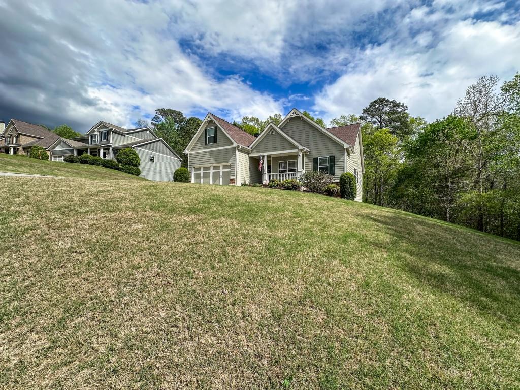 261 Potomac Drive Dallas, GA 30132 - Photo 11 of 76 a front view of a house with a garden