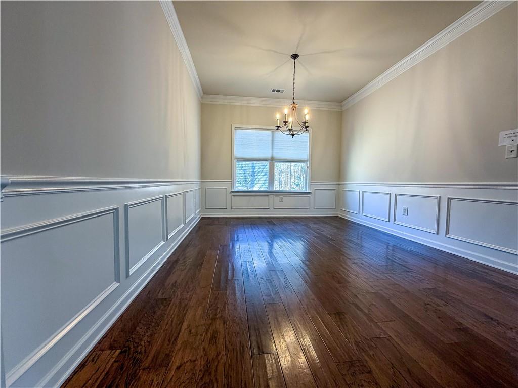 261 Potomac Drive Dallas, GA 30132 - Photo 17 of 76 a view of an empty room with wooden floor and a window