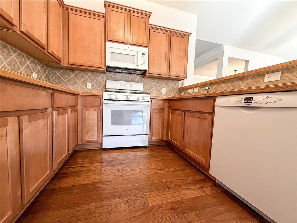 261 Potomac Drive Dallas, GA 30132 - Photo 19 of 76 a kitchen with stainless steel appliances granite countertop a stove a sink and a microwave