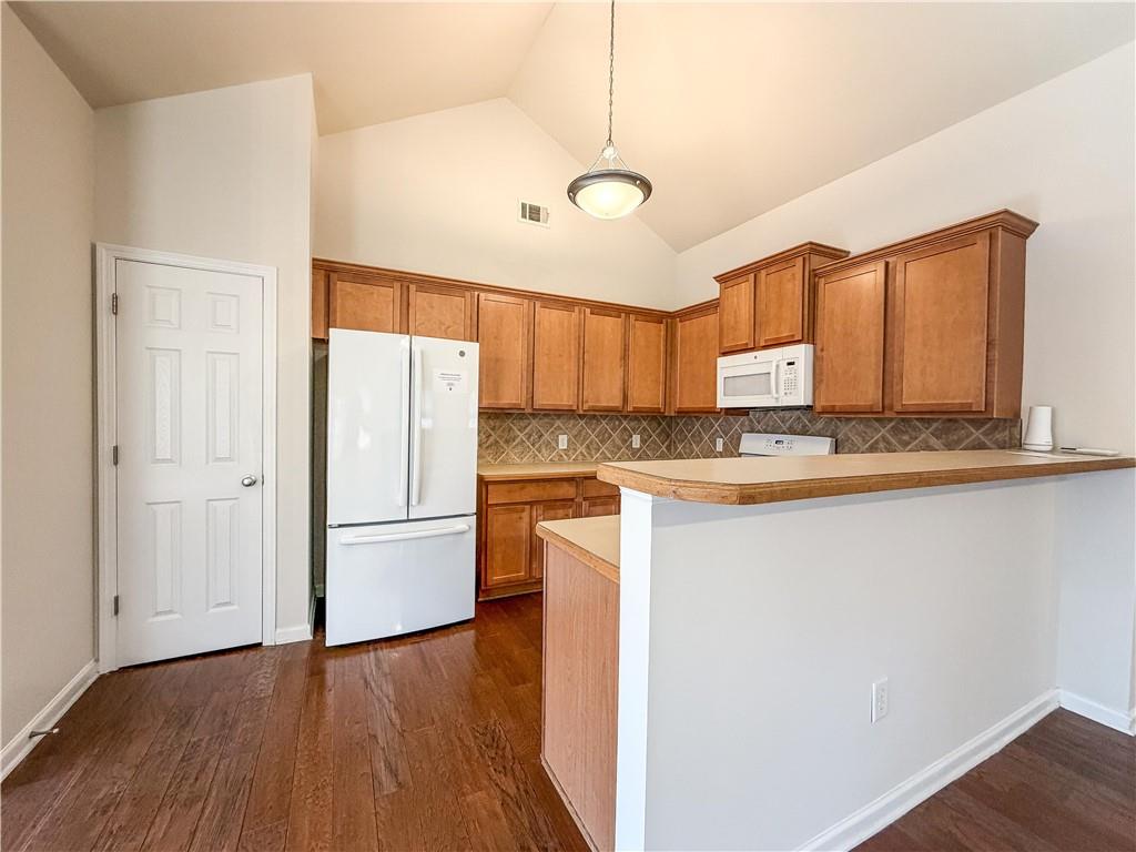 261 Potomac Drive Dallas, GA 30132 - Photo 20 of 76 a kitchen with granite countertop a refrigerator and a stove top oven