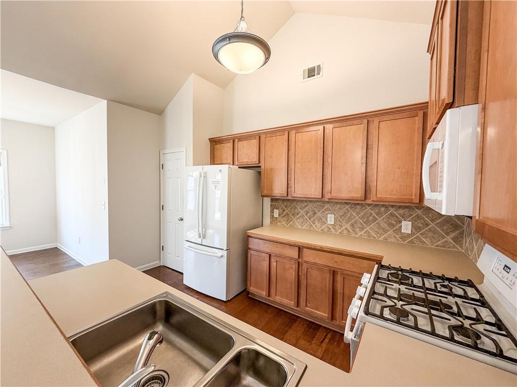 261 Potomac Drive Dallas, GA 30132 - Photo 21 of 76 a kitchen with a refrigerator and a stove top oven