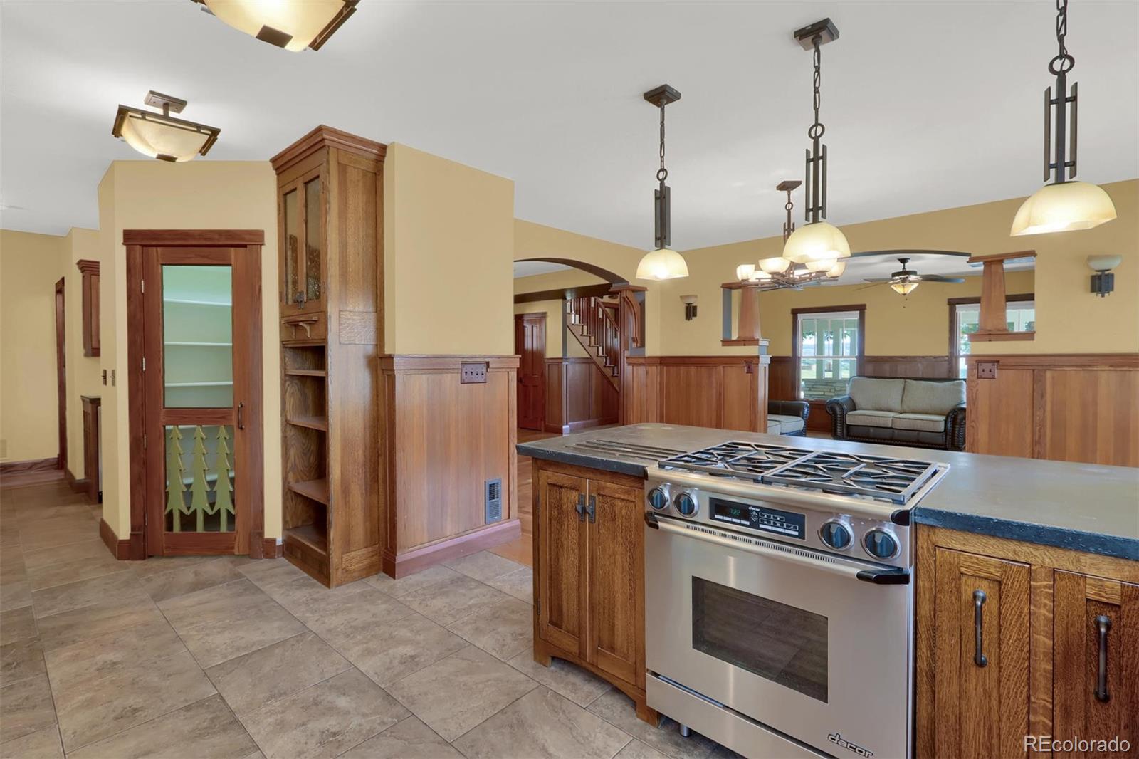 3045 Hay Creek Road Colorado Springs, CO 80921 - Photo 14 of 40 a kitchen that has a stove and a wooden floor
