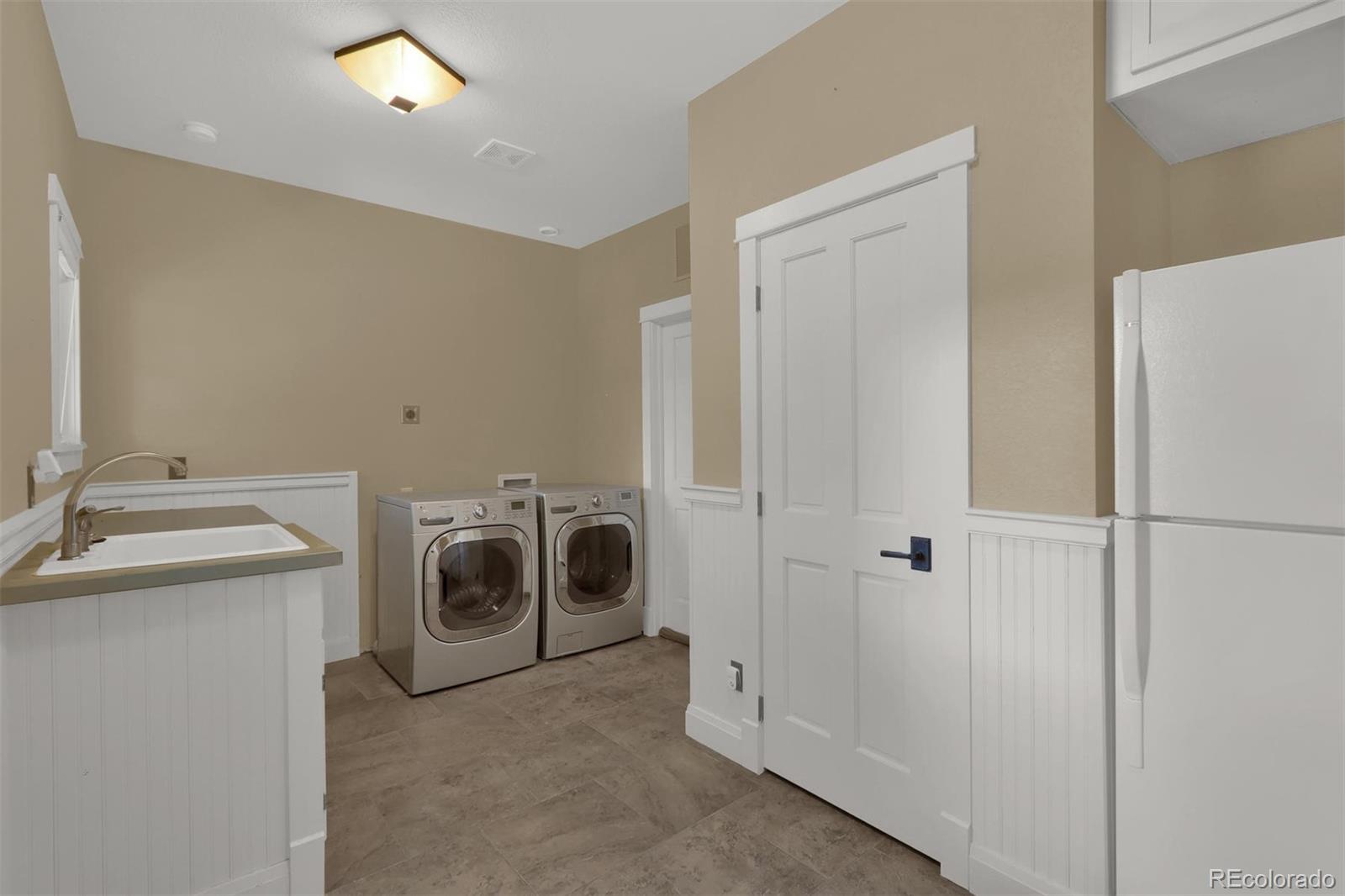 3045 Hay Creek Road Colorado Springs, CO 80921 - Photo 16 of 40 a utility room with dryer and washer