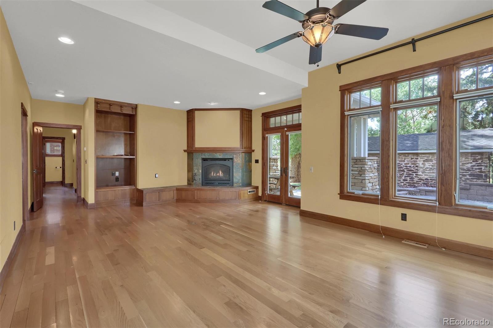3045 Hay Creek Road Colorado Springs, CO 80921 - Photo 19 of 40 an empty room with windows and fireplace
