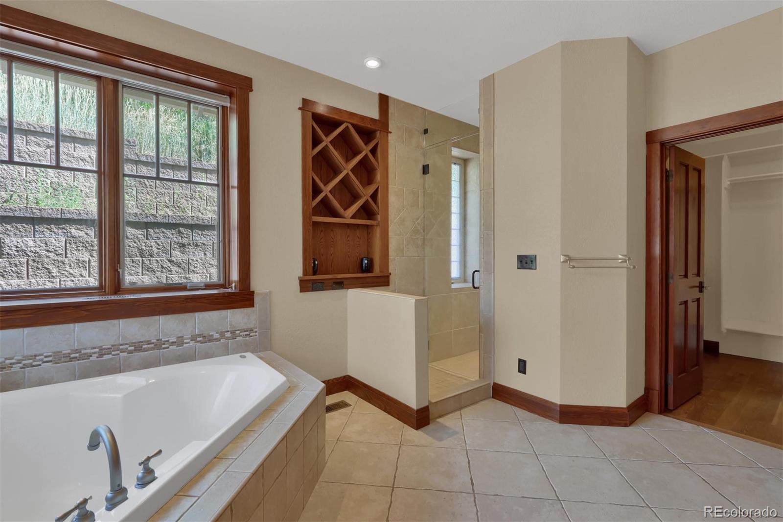 3045 Hay Creek Road Colorado Springs, CO 80921 - Photo 20 of 40 a bathroom with a tub and a window