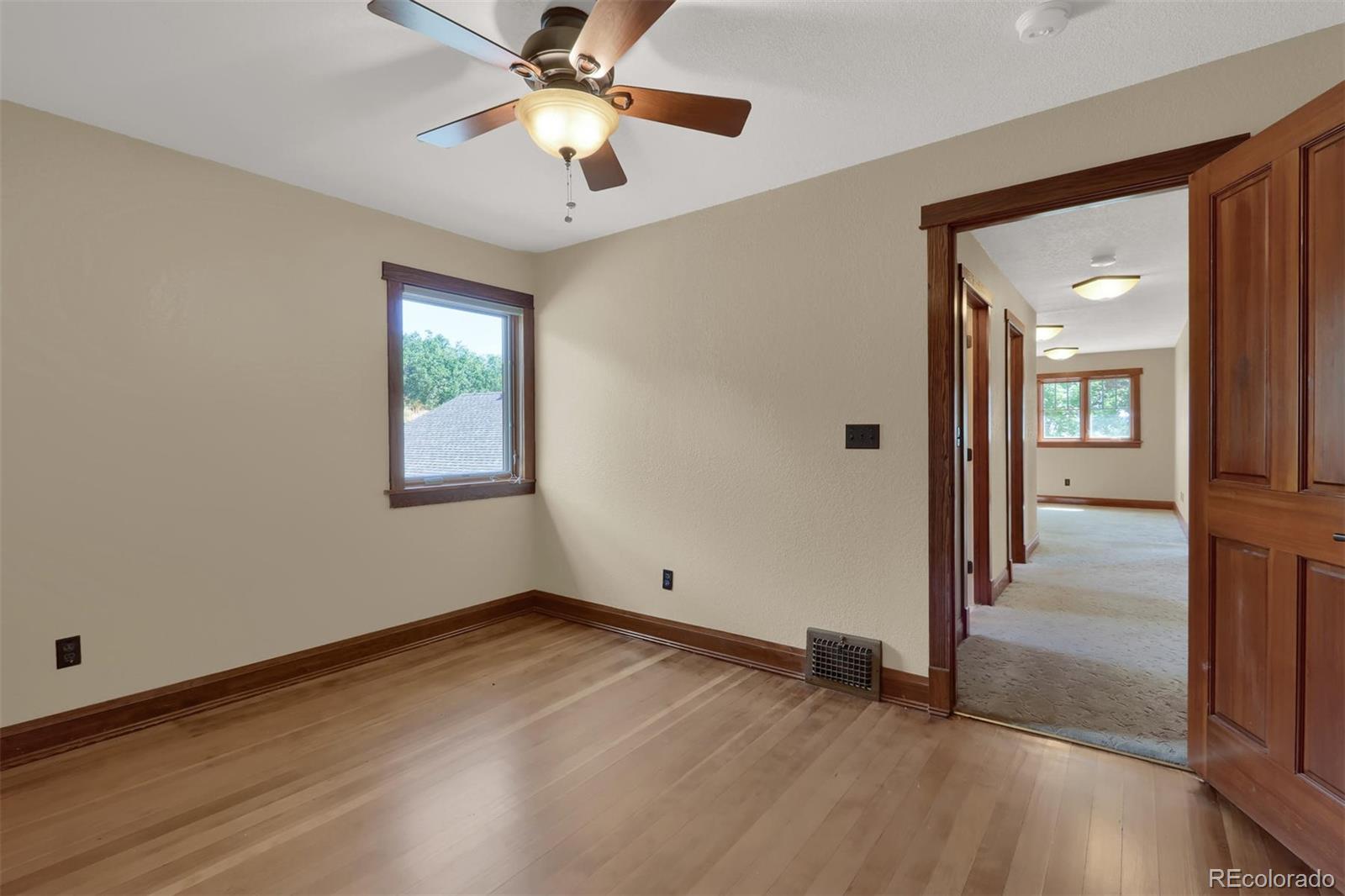 3045 Hay Creek Road Colorado Springs, CO 80921 - Photo 24 of 40 wooden floor in an empty room with a window
