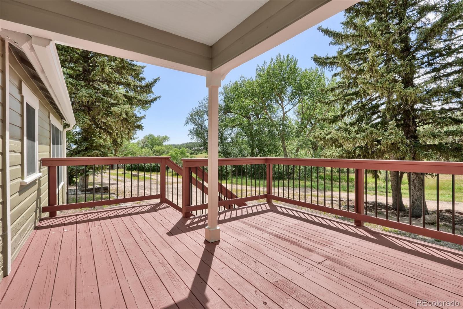 3045 Hay Creek Road Colorado Springs, CO 80921 - Photo 29 of 40 a view of balcony with wooden floor and fence