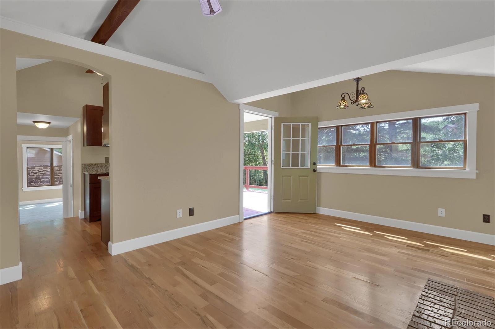 3045 Hay Creek Road Colorado Springs, CO 80921 - Photo 30 of 40 a view of an empty room with wooden floor and a window